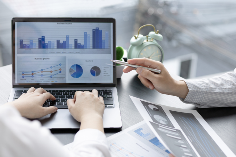 people collaborating on marketing plan and looking at tables on computer